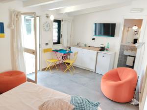 a kitchen with a table and chairs in a room at La casa tra le vie in Viagrande