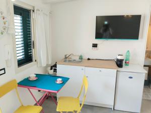 a kitchen with a table and a small table with chairs at La casa tra le vie in Viagrande +7 photos