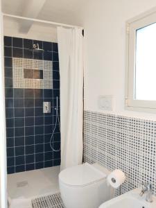 a bathroom with a toilet and a sink and a shower at La casa tra le vie in Viagrande