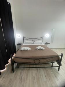 a bedroom with a bed with two towels on it at Loft Home Sweet Home in Catania