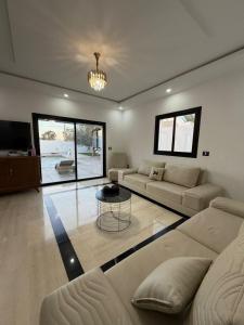 a living room with a couch and a table at Montaseur s3 in Al Maqārisah