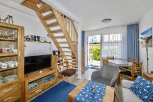 a living room with a staircase leading to a living room at Ferienwohnung AHOI Thiessow in Thiessow