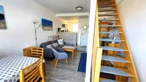 a staircase leading to a living room and a living room at Ferienwohnung AHOI Thiessow in Thiessow