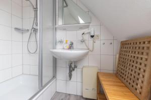a bathroom with a sink and a shower at Ferienwohnung AHOI Thiessow in Thiessow +25 photos