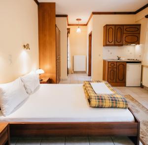 un letto grande in una stanza con cucina di Studios ΕΥΤΥΧΙΑ-6 a Kalavrita