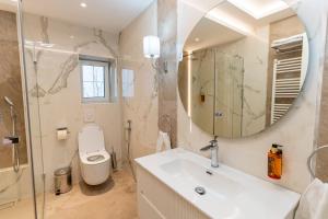 a bathroom with a sink and a toilet and a mirror at Crama Venetic in Prundeni +79 photos
