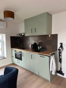 a kitchen with white cabinets and a counter top at 't Veurhuus in Ansen