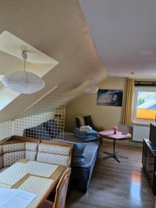 a living room with a couch and a table at Birkenstübchen in Lautenthal