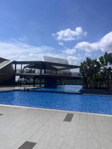 a large swimming pool with a bridge in the background at Adelia SweetHome in Kajang