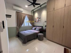 a small bedroom with a bed and a window at Adelia SweetHome in Kajang +3 photos