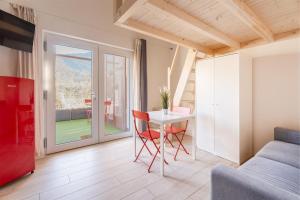 a living room with a table and a couch at Conca d'Oro Apartments, camera 1 e 2 in Nago-Torbole