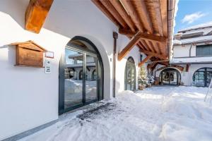 a building with snow on the ground in front of it at Hostdomus - Nube d'Argento in Sestriere