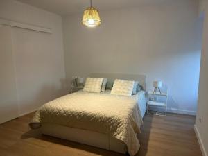 a bedroom with a bed with two pillows on it at Refúgio do Ribeirinho in Paredes de Coura