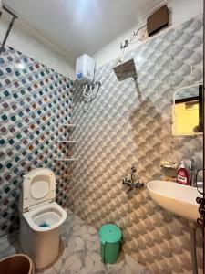 a bathroom with a toilet and a sink at Captains cabin in Tikri Kalān +16 photos