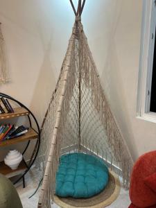 a hammock bed in the corner of a room at Simbas Den by Abodeandco in Dehradun +4 photos
