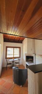 a living room with a table and a fireplace at hotel fazenda ctk in Santa Cruz do Sul