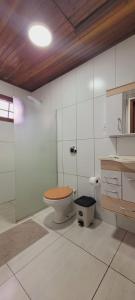 a white bathroom with a toilet and a sink at hotel fazenda ctk in Santa Cruz do Sul