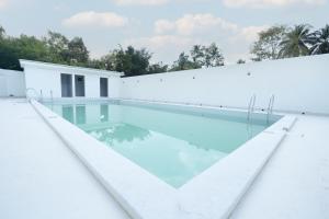 a swimming pool on the roof of a house at Rasha Suites in Kalpetta