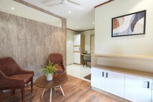 a living room with two chairs and a table at Rasha Suites in Kalpetta