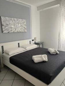 a bedroom with a bed with two towels on it at FUORI PORTA NUOVA in Sarzana