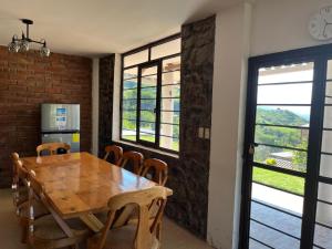 a dining room with a wooden table and chairs at Casa Vacacional in Loja