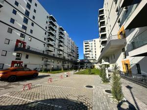 a car parked in a parking lot next to tall buildings at Garsoniera lux in Craiova