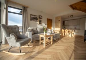 a living room with a couch and a table at Domki Tomanova - Premium Chalets in Dzianisz