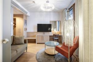 a living room with a couch and a table at Scandic Oulu City in Oulu