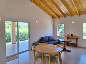 a living room with a table and a couch at Casa Rincon in Villa General Belgrano