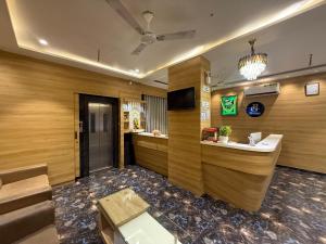 a lobby of a hotel with a reception desk at Hotel Krish villa in Vadodara