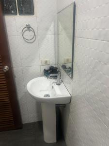a bathroom with a white sink and a mirror at Uncle Toy in Ban Riang +8 photos