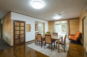 a dining room with a table and chairs at Lake&Mountain Hamamatsu inn in Hamamatsu
