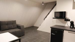 a living room with a couch and a microwave at Rancho in Ladyzhyn
