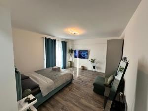 a bedroom with a bed and a chair in it at Garsoniera lux in Craiova
