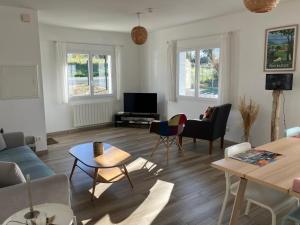 a living room with a couch and chairs at Maison Gure Chokoa Pays Basque in Bardos