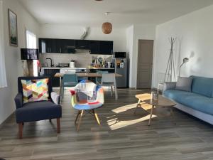 a living room with a blue couch and chairs at Maison Gure Chokoa Pays Basque in Bardos