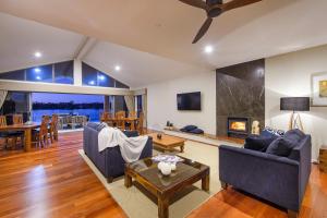 a living room with a couch and a table at Ana Mandara Luxury Retreat in Port Macquarie