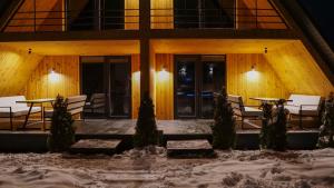a house in the snow with tables and chairs at Rancho in Ladyzhyn