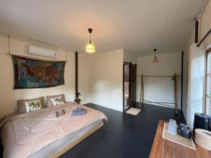 a bedroom with a large bed in a room at Baan Rim Len Koh Kood in Ko Kood