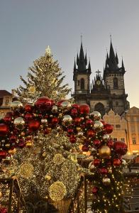 a christmas tree and decorations in front of a building at Hotel Metamorphis in Prague