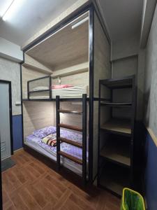 a couple of bunk beds in a room at WannaB Hostel in Khlong San