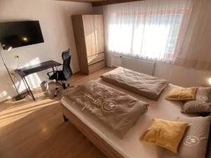 En eller flere senge i et værelse på Ferienhaus zur Weinlaube