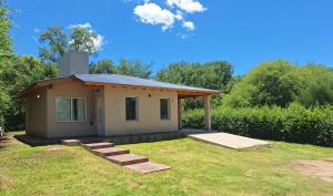 a small house in a yard with a grass field at Casa Rincon in Villa General Belgrano +12 photos