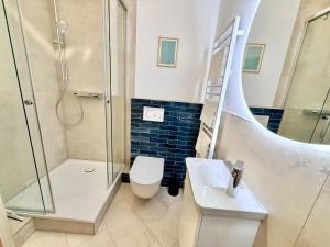 a bathroom with a shower and a toilet and a sink at Kajuete, direkt am Kurpark in Warnemünde +15 photos