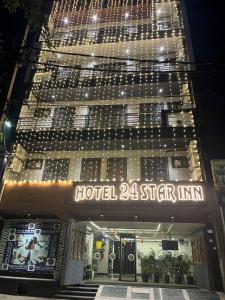 a hotel star inn is lit up at night at Hotel 24 STAR INN in Jāmb