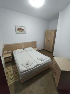 a small bedroom with a bed and a table at Aparthotel Winslow Highland in Bansko