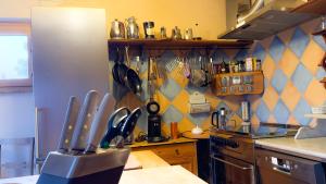 a kitchen with a bunch of utensils on a wall at Wie im Himmel in Hatzfeld +19 photos