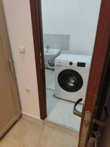 a bathroom with a washing machine and a sink at Aparthotel Winslow Highland in Bansko +22 photos