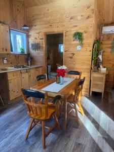 ein Esszimmer mit einem Holztisch und Stühlen in der Unterkunft Le Richelieu in St-Bernard de Lacolle
