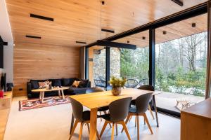a living room with a table and chairs at Zacisze Gór by Apart Concept Podhale in Zakopane